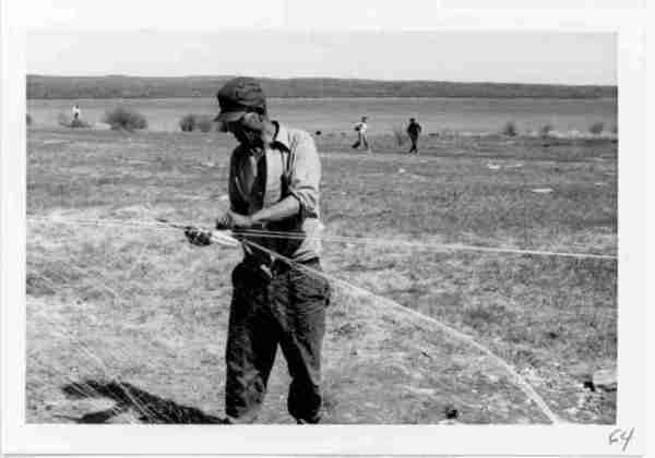 Photograph of Roderick Yooya stringing fishnet. S. June, 1971. Stony Rapids Project, Folder 2, R.M. Bone fonds. University of Saskatchewan Archives II.